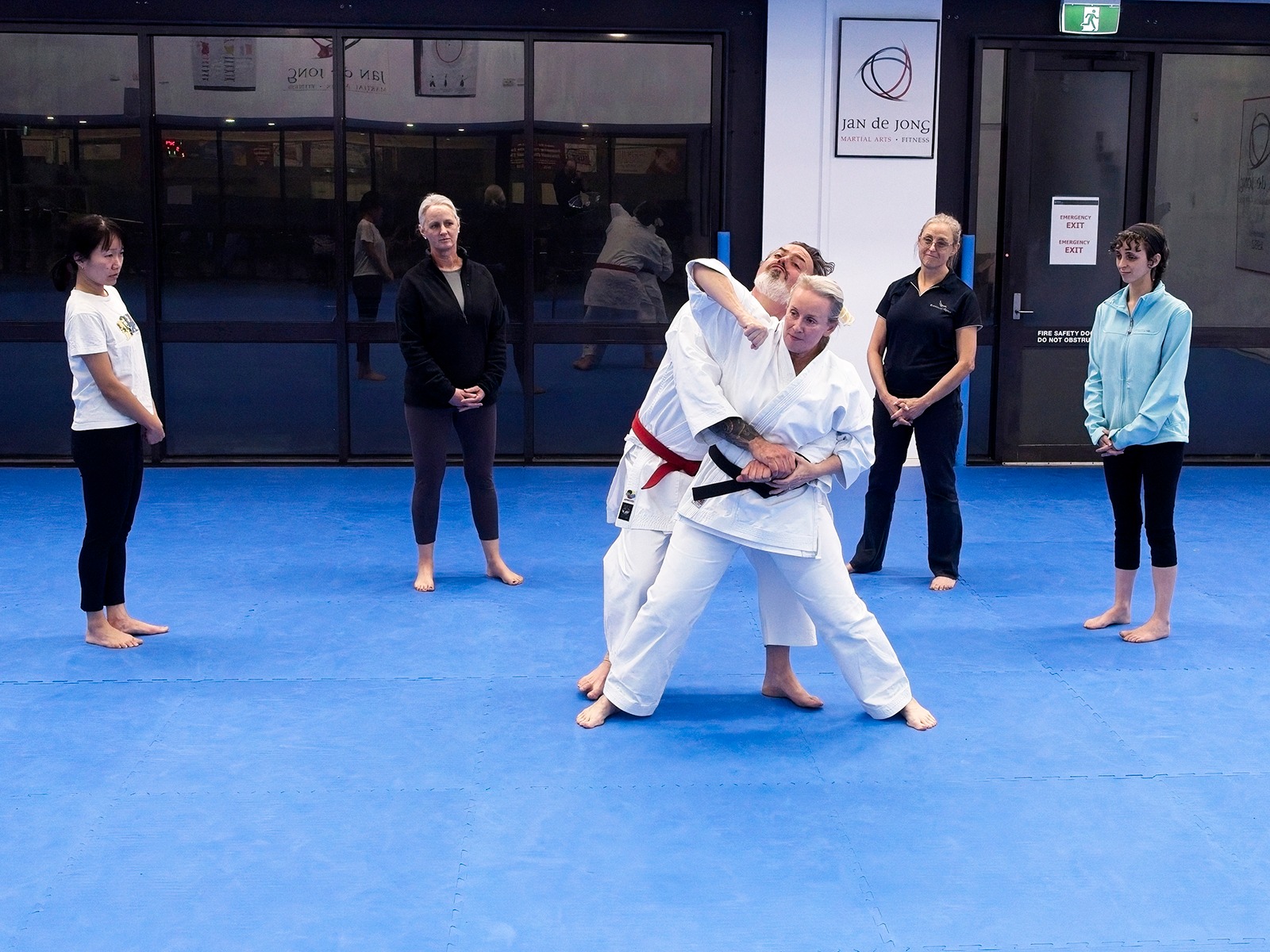Self defense class demonstrating rear attack defense